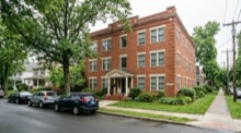 A brick apartment building on a city street